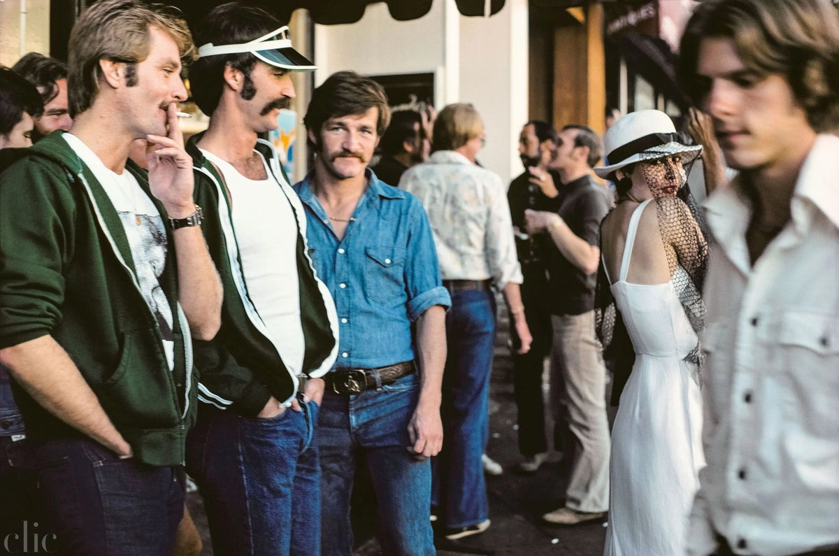 Group of people in a street scene with vintage clothing