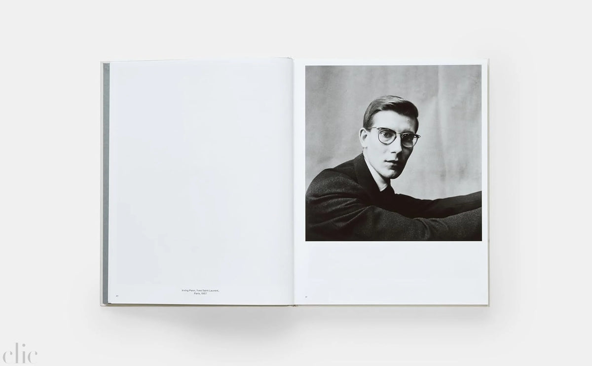 Open book displaying a black and white photograph of a man with glasses on a white background