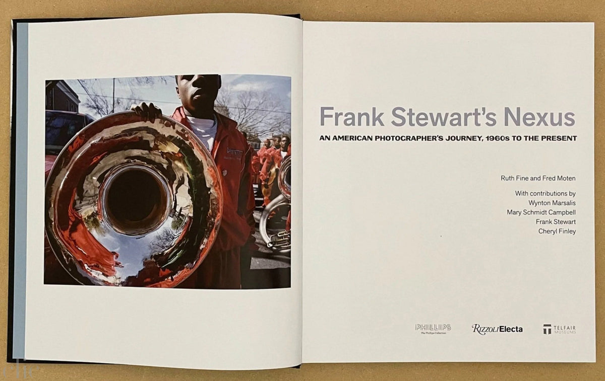 Open book showing a photograph and text about Frank Stewart's work.