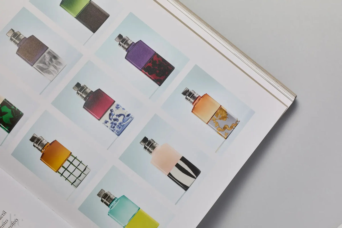 Book open to a page with images of colorful perfume bottles.