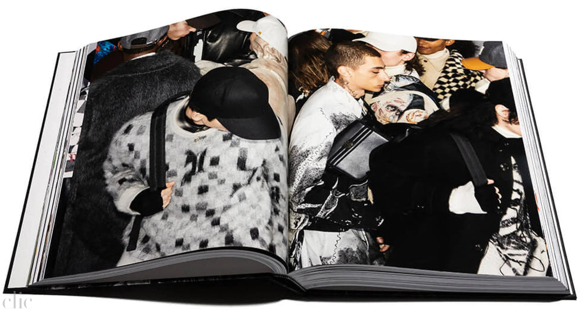 Open book showing a crowd of people in various outfts.