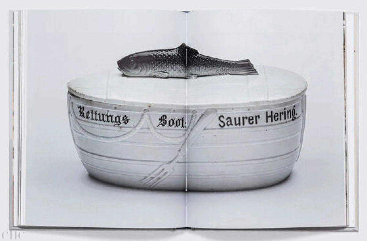 Open book showing a black and white photograph of a bowl with text on a white background