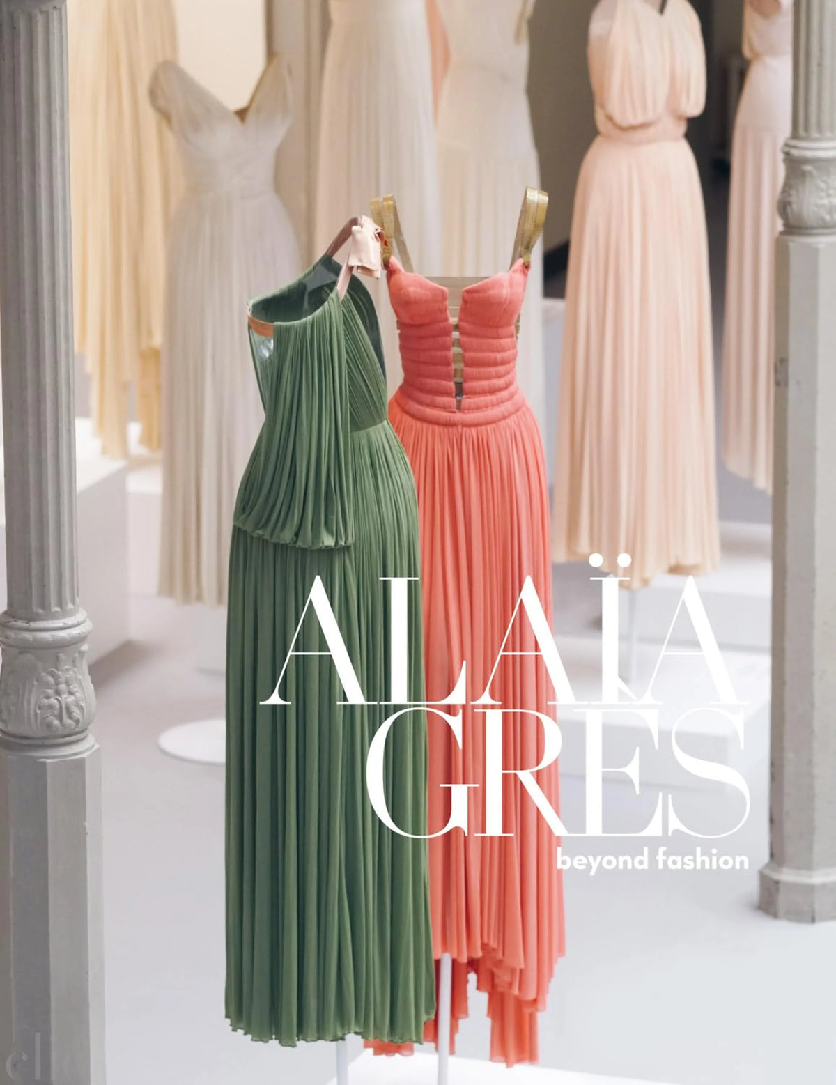 Two dresses, one green and one pink, on mannequins.