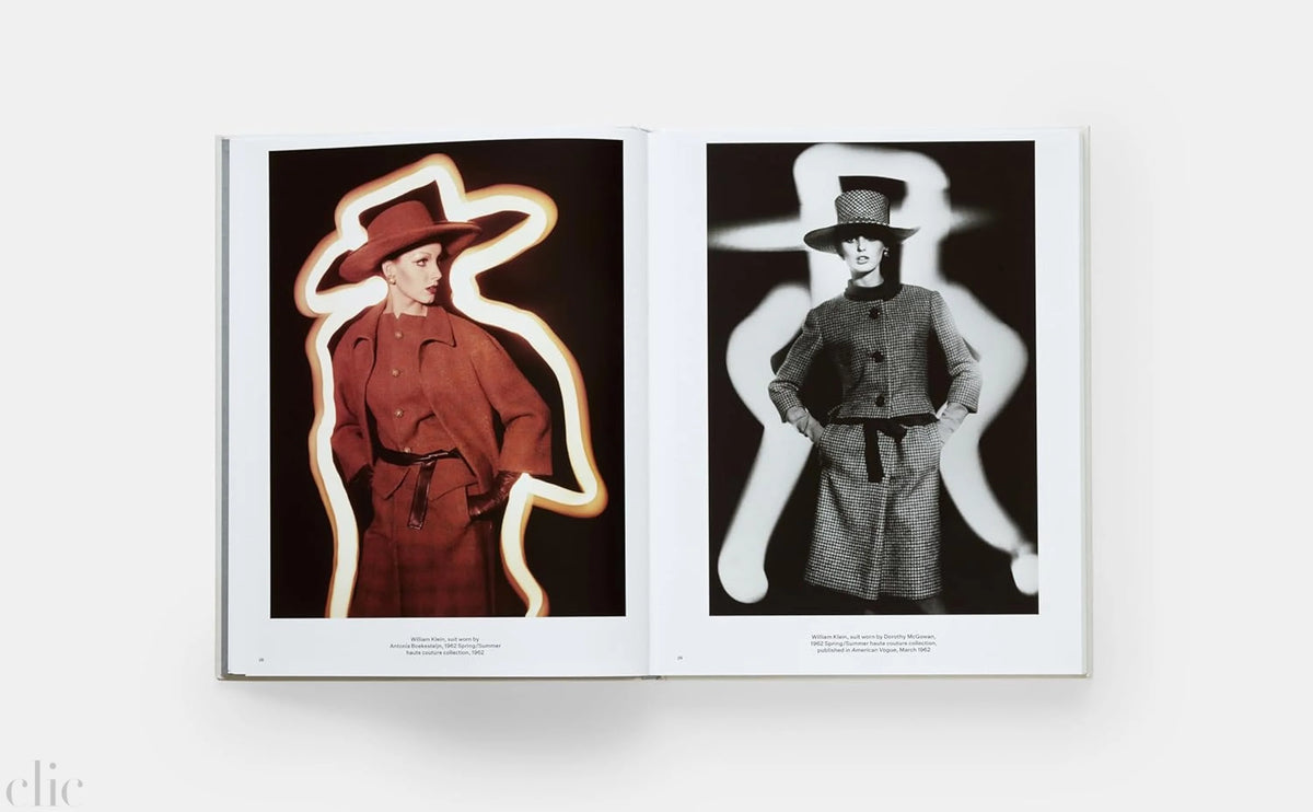 Open book showing two fashion photographs of models wearing trench coats and hats.