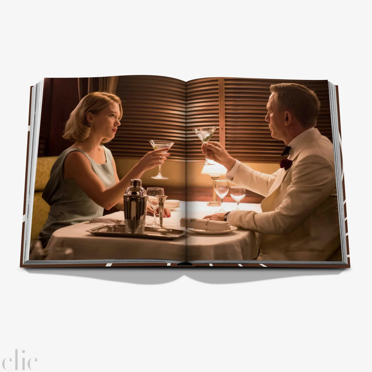 Open book showing a couple at a dinner table with drinks.