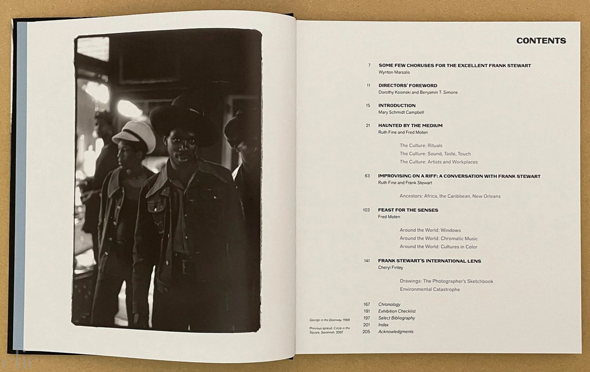 Open book showing a black and white photo on the left and a table of contents on the right.