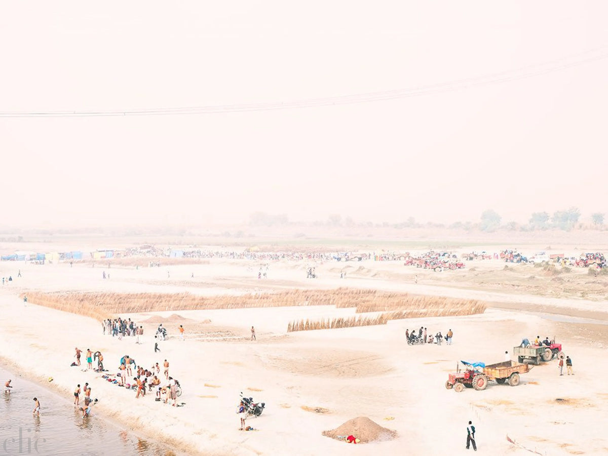 Scene with people and a tractor on a sandy shore