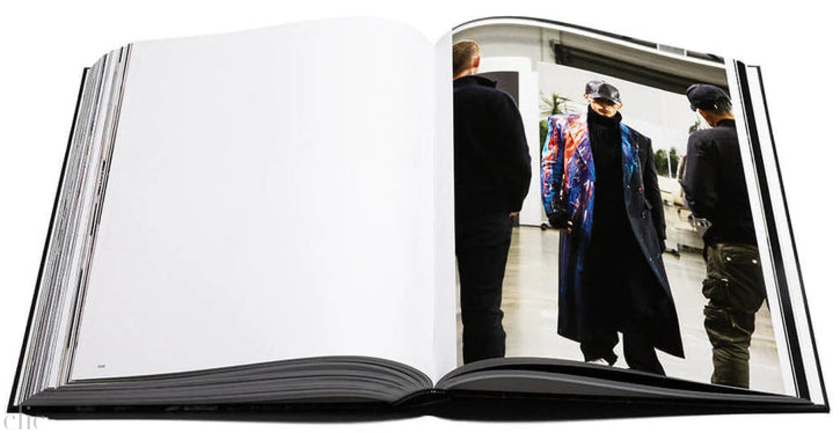 Open book showing a photograph of people in a room.