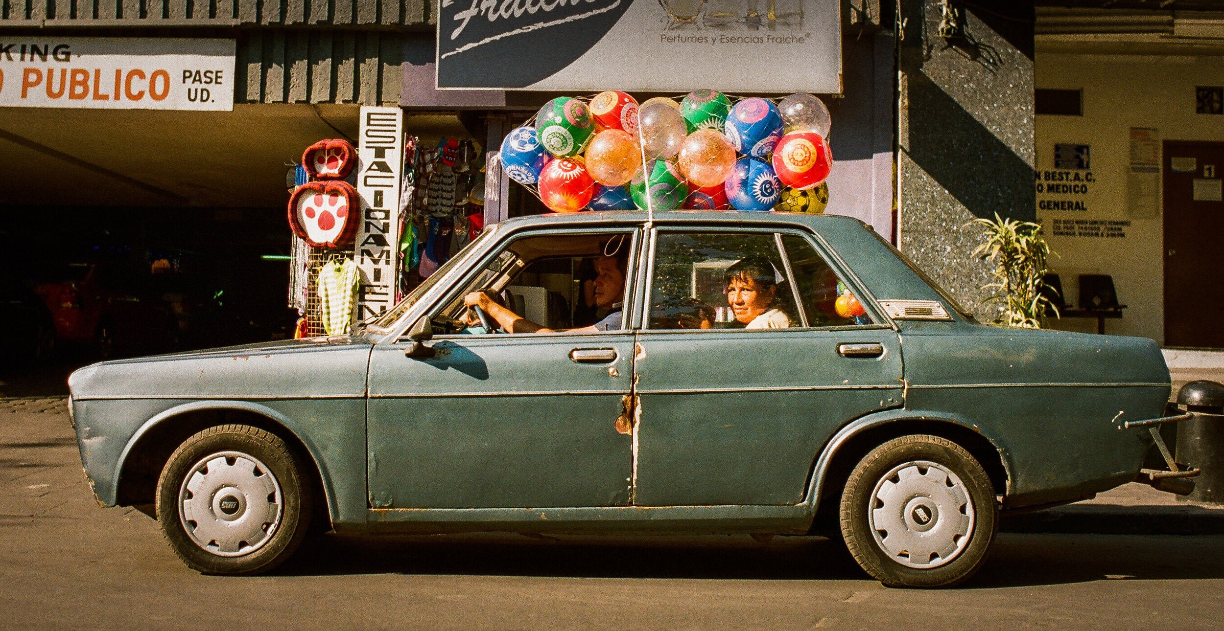 Car With Balloons by Josh Soskin