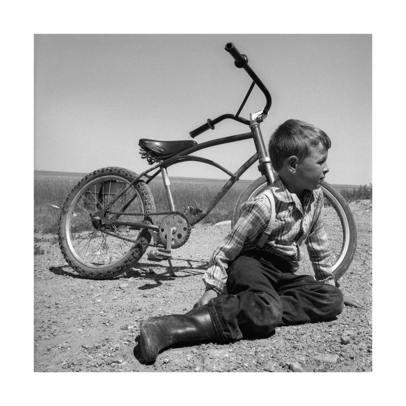 Hutterite Boy and His Bike, 1983 by Drew Carolan